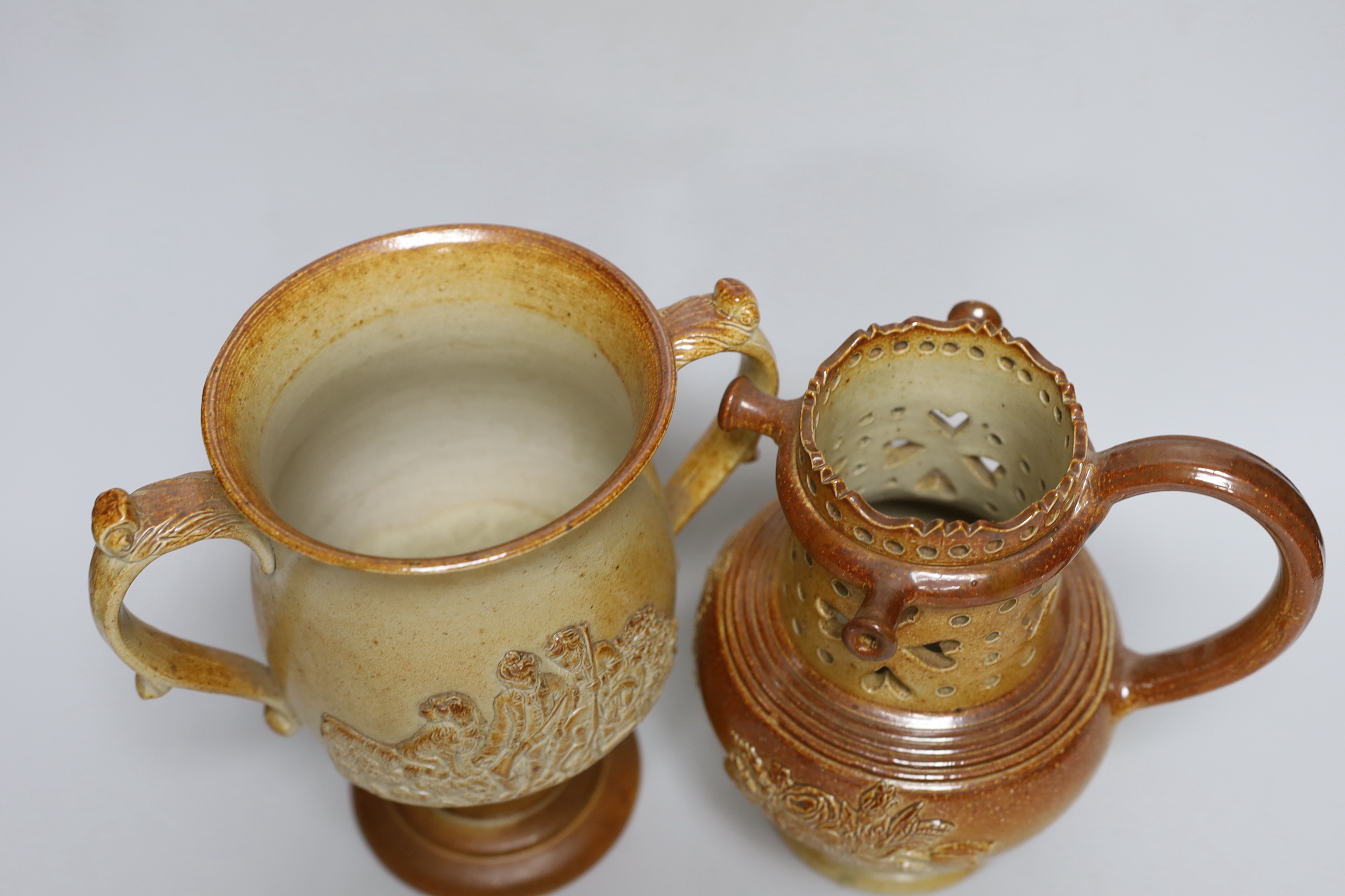 A Brampton salt glazed stoneware puzzle jug and a similar two handled loving cup, c.1840, tallest 21cm